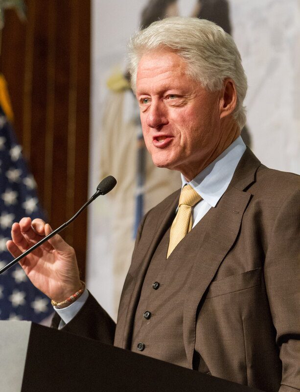 Former U.S. president Bill Clinton speaking at a podium