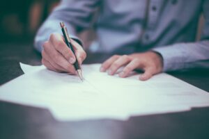 A lawyer signs paperwork necessary for estate planning