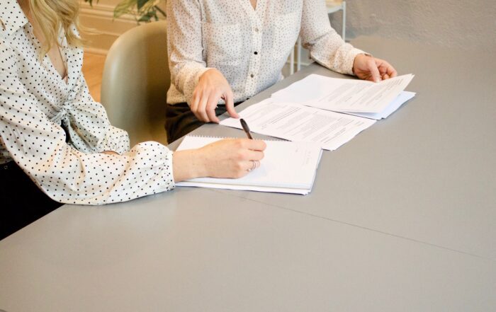 A lawyer meeting with her client to prepare the documents for estate planning