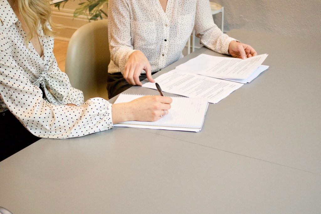 A lawyer meeting with her client to prepare the documents for estate planning