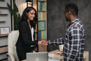 A paralegal woman shaking hands with a man